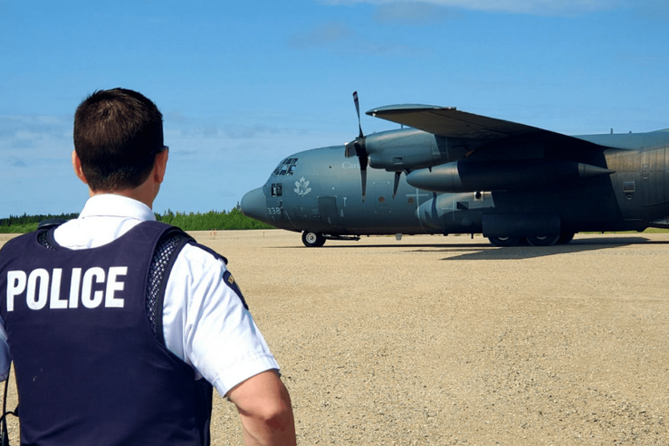 A RCAF transport arrives with supplies and more searchers to join the hunt for the teen suspects.
