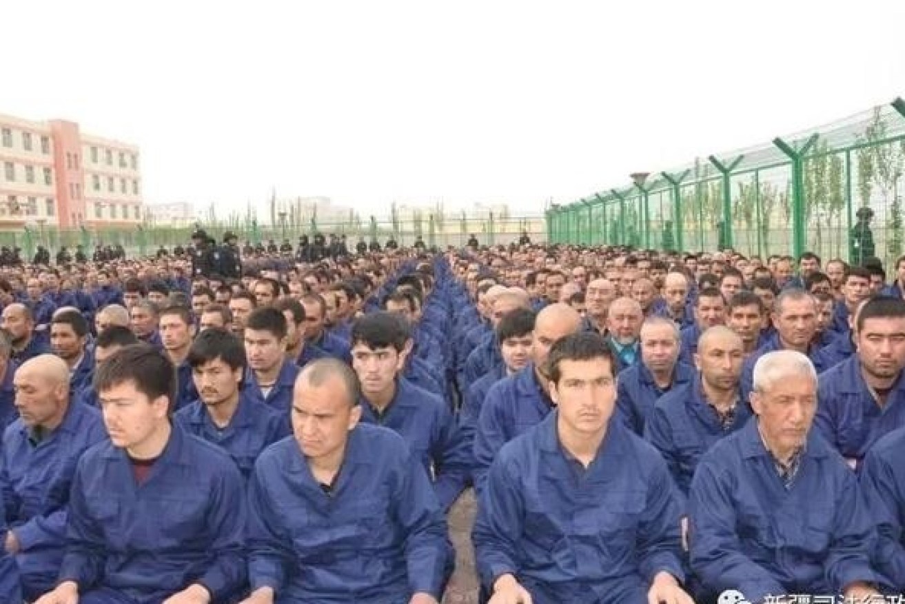 Uighur detainees are forced to listen to  "de-radicalisation" lectures in a Xinjiang labor camp. 