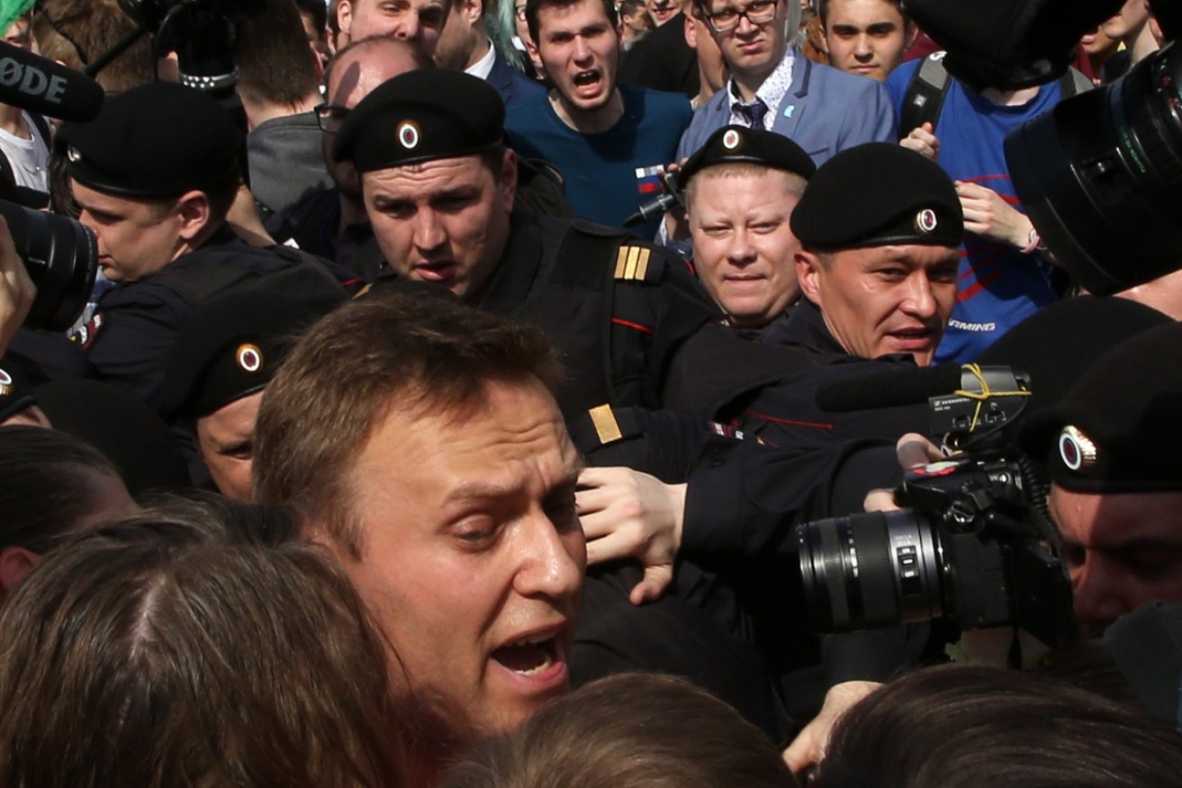 Alexei Navalny is surrounded by riot police at a rally in Moscow in 2018.