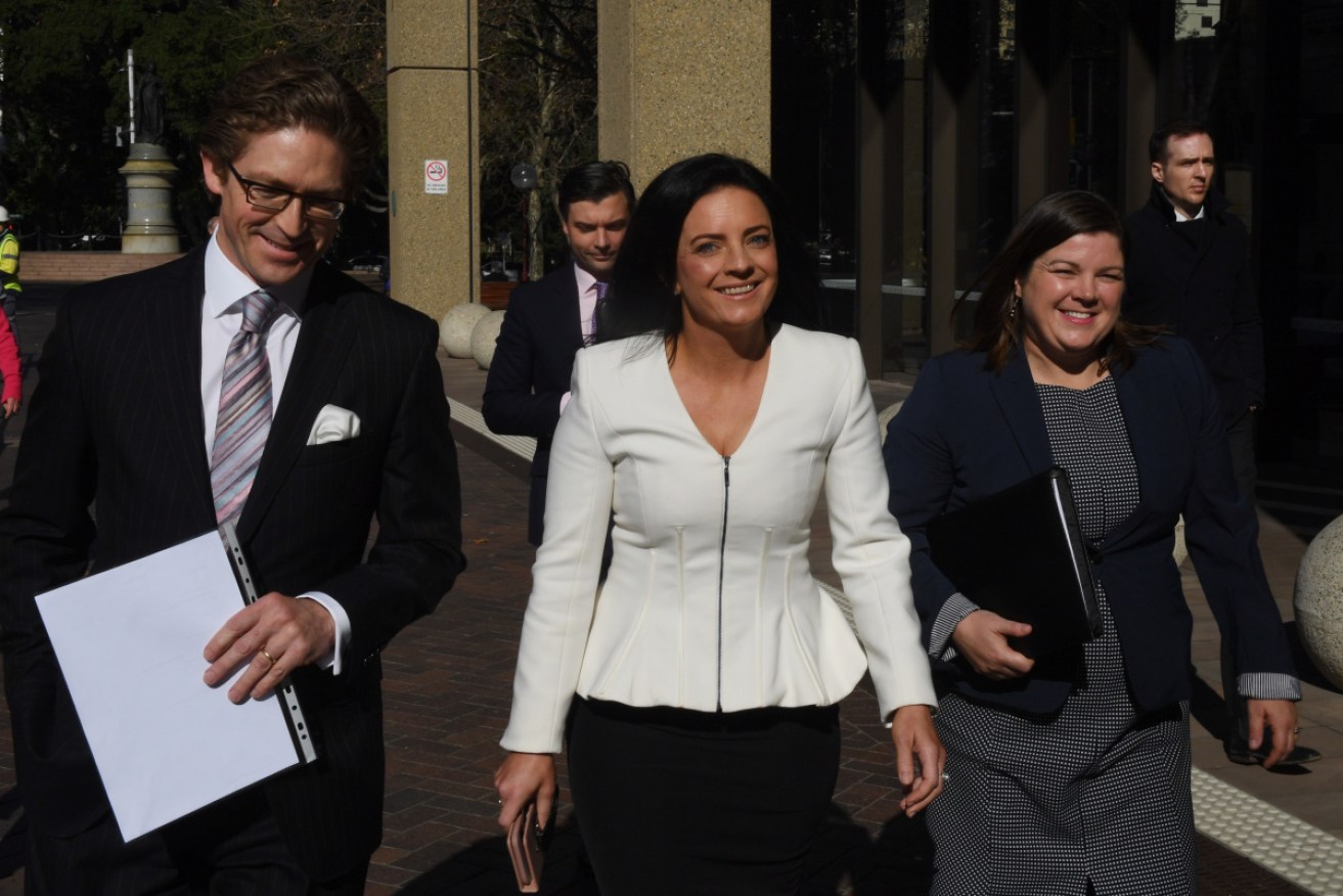 Emma Husar leaves court with her lawyers. 