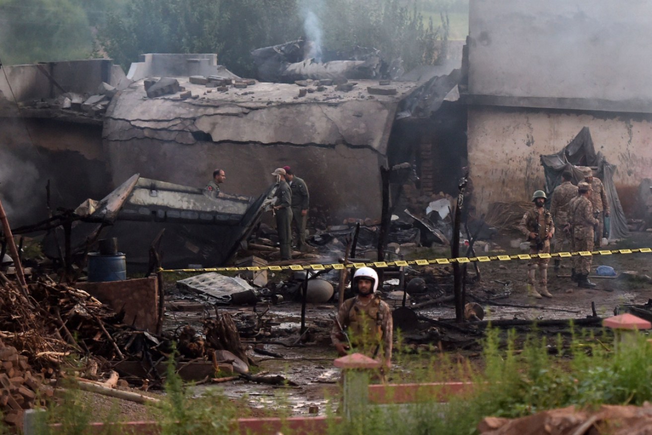 Military personnel work at the scene where a Pakistani Army Aviation Corps aircraft crashed in Rawalpindi.