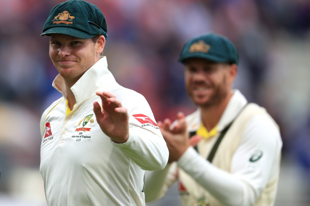 Steve Smith acknowledges the support of his teammates as he leaves the ground at the end of day one of the first test. 
