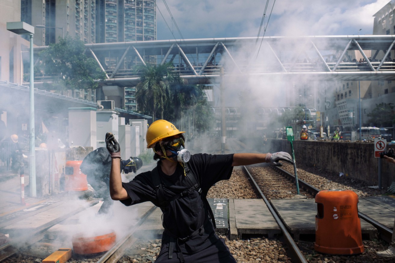 A protester responds to rubber bullets and tear gas during Hong Hong's three months of turmoil.