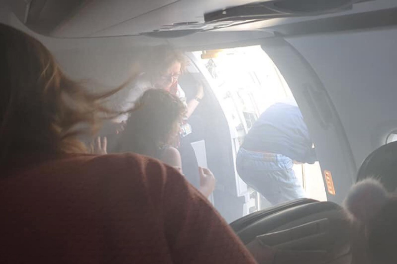 Passengers were ushered off the smoke-filled plane and down emergency slides.