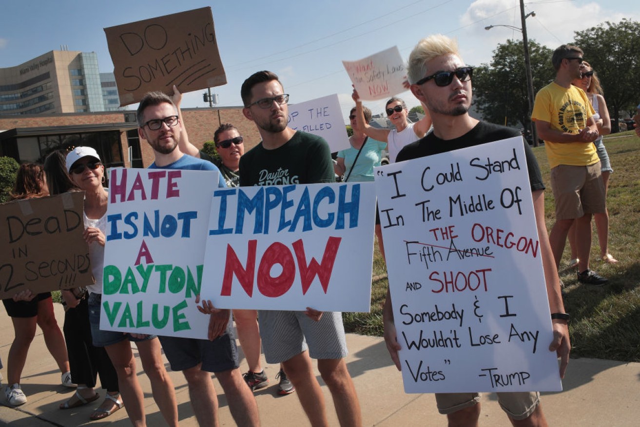 Demonstrators express their upset towards Donald Trump on his visit to Dayton, Ohio.