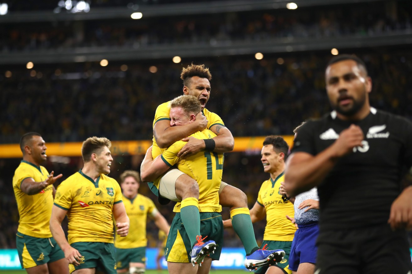Australia celebrates another try and the All Blacks stumble. 