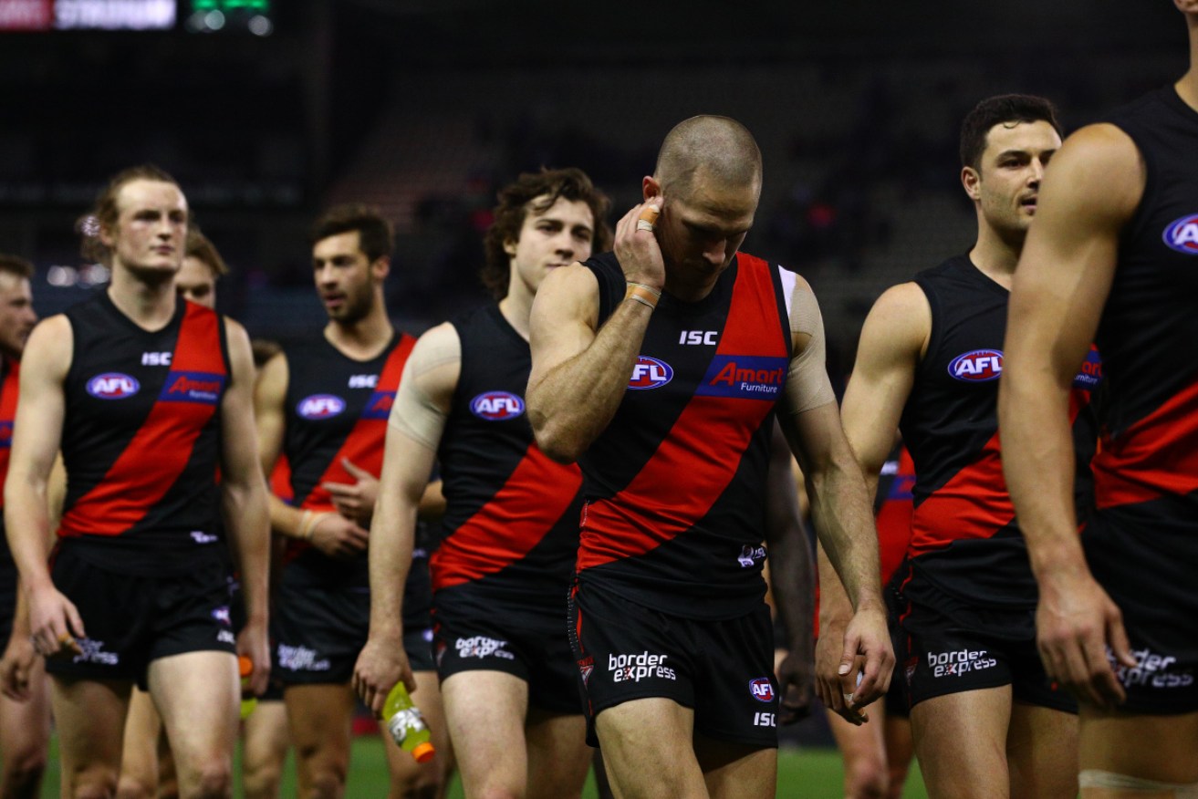 Essendon players trudge off after a disastrous game against the Western Bulldogs. 