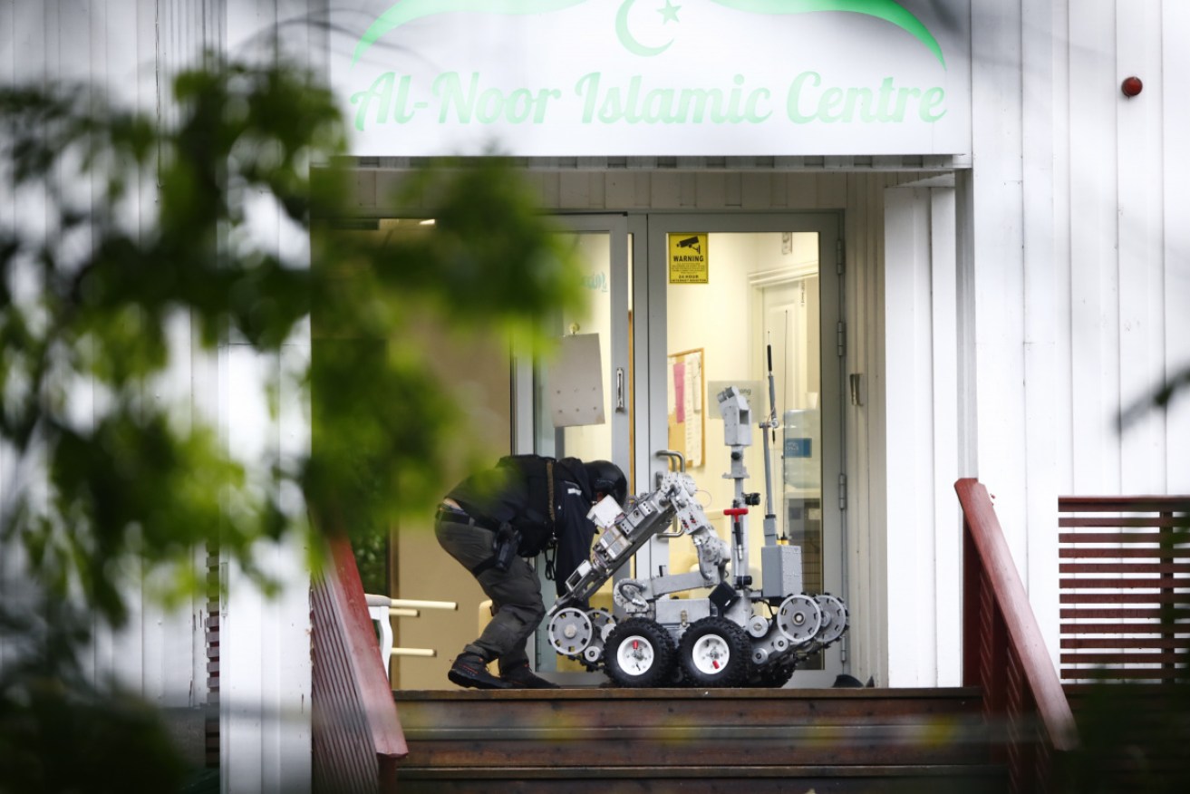 A police officer attends to a robot at the site of the shooting at the al-Noor Islamic Centre in Oslo. 