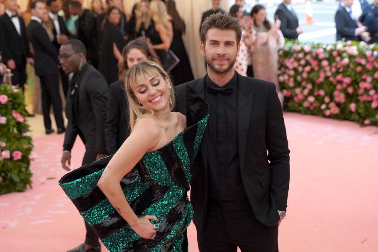 Miley Cyrus and Liam Hemsworth were all smiles on the red carpet at May 6's Met Gala in New York.