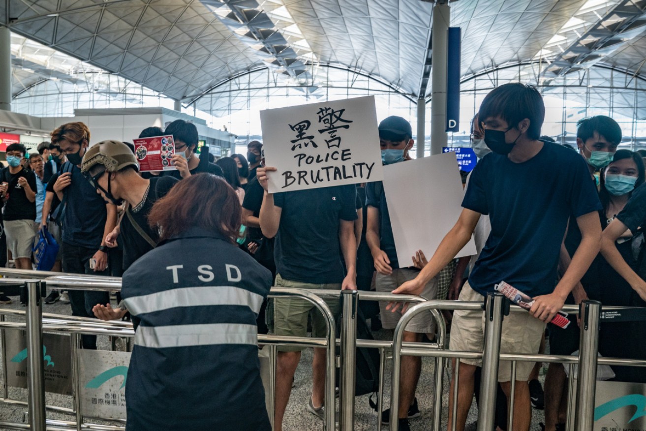 Protesters remove barricade at the airport departure hall. Photo: Getty 