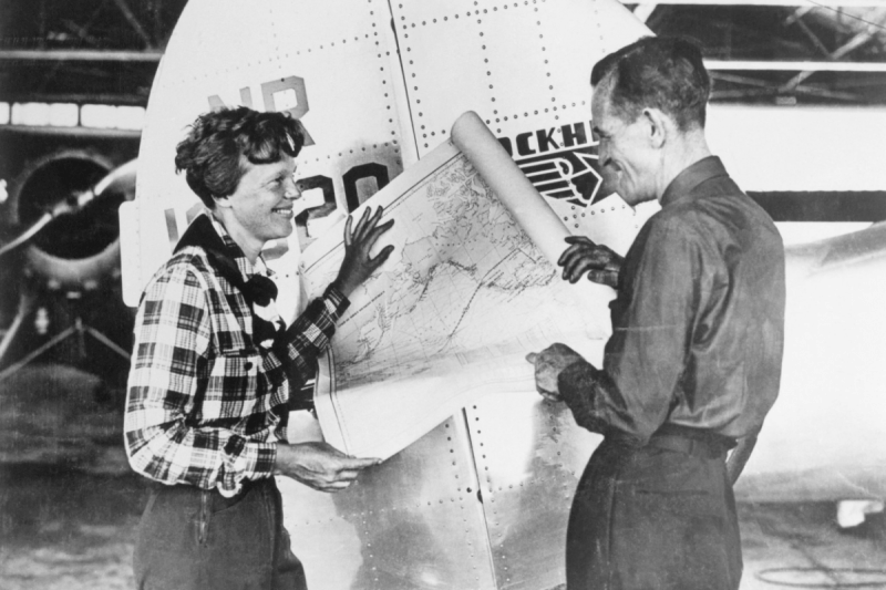 Ms. Earhart and navigator Fred Noonan, holding a map that shows the route of their last flight. Photo: Getty
