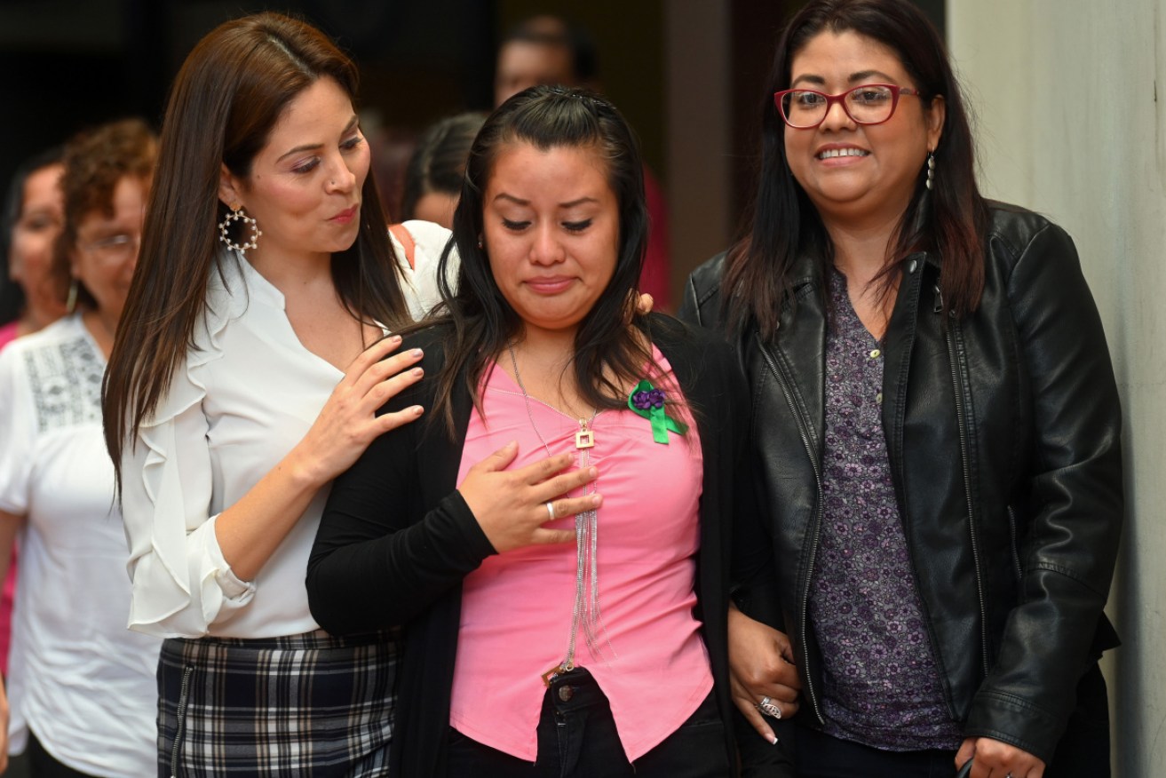 Salvadorean rape victim Evelyn Hernandez (centre) is accompanied by her lawyers after being cleared of murder after giving birth to a stillborn baby at home in 2016.