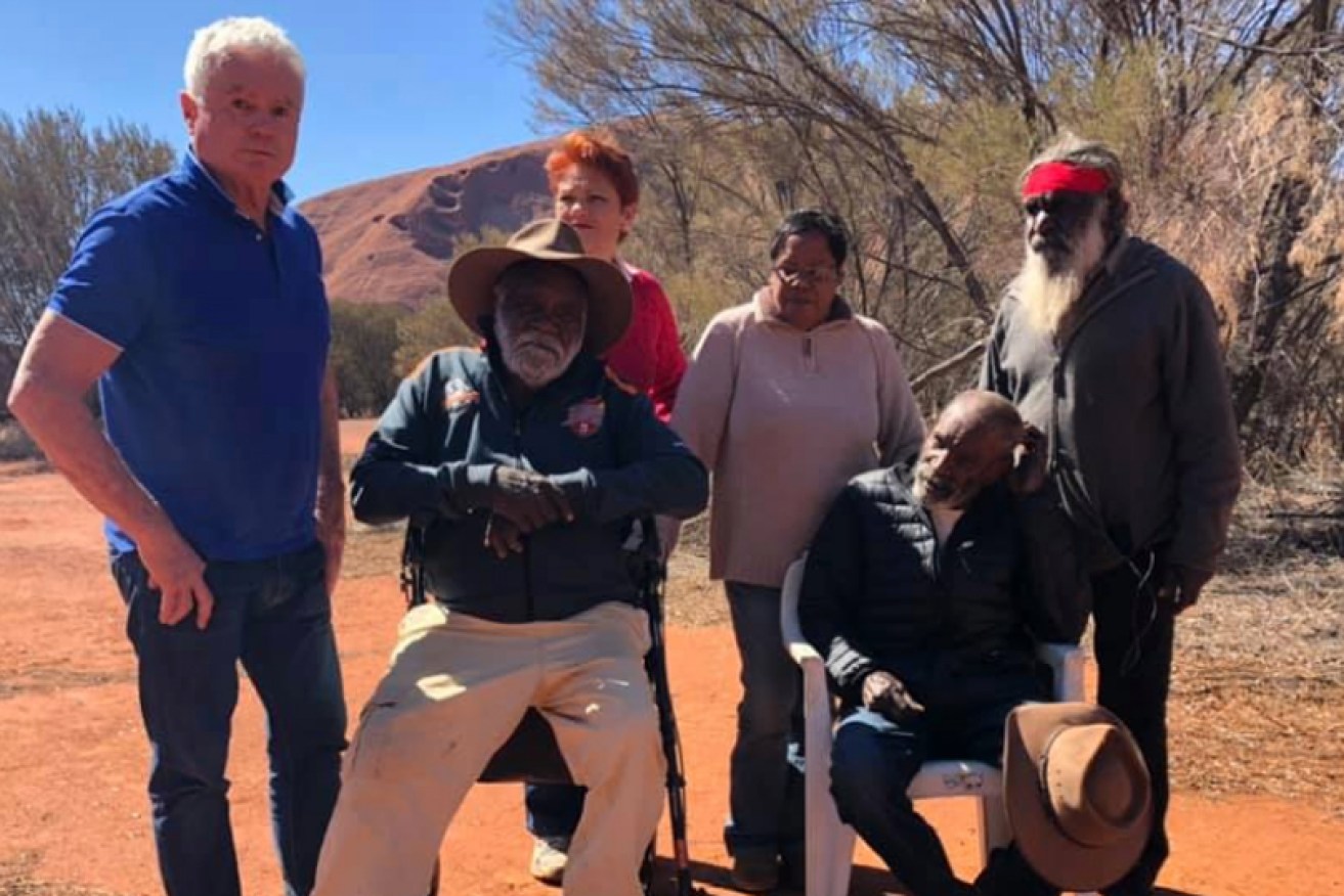 Pauline Hanson at Uluru with Reggie and Cassidy Uluru from the Anangu Mayatja Council of Elders, and the Nine Network's Martin King.