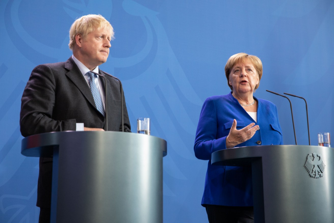 British Prime Minister Boris Johnson and German Chancellor Angela Merkel attend a joint press conference  in Berlin. 