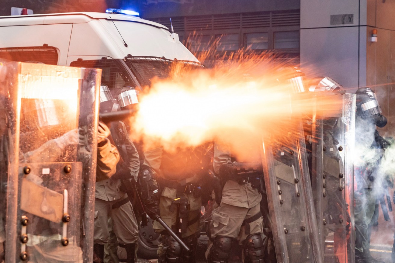 Riot police fire tear gas at protesters at an anti-government rally in Tsuen Wan district on Sunday. 
