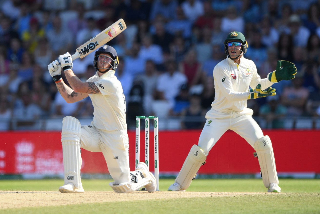Australian skipper Tim Paine watches on from behind the stumps as Ben Stokes hits another six. 