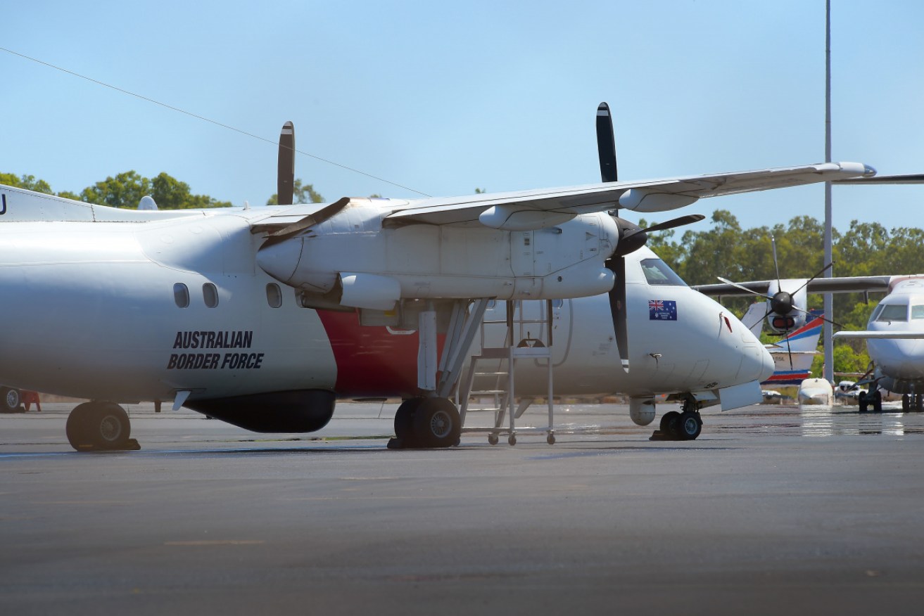 An Australian Border Force aircraft waits at Darwin airport ready to transport the family to Christmas Island.