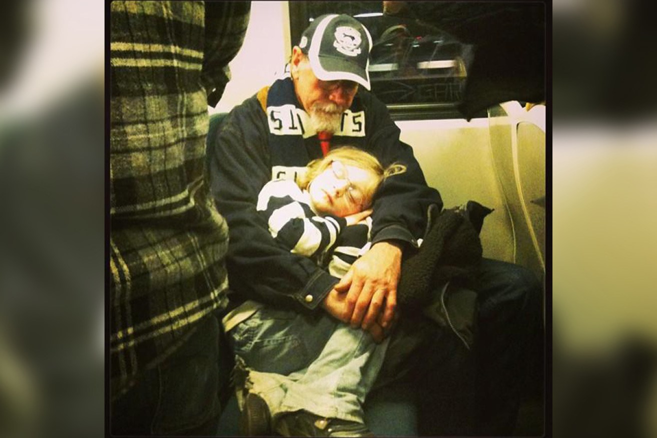 Dad as Poppy with his eldest grandchild, on the train home after yet another Geelong victory.