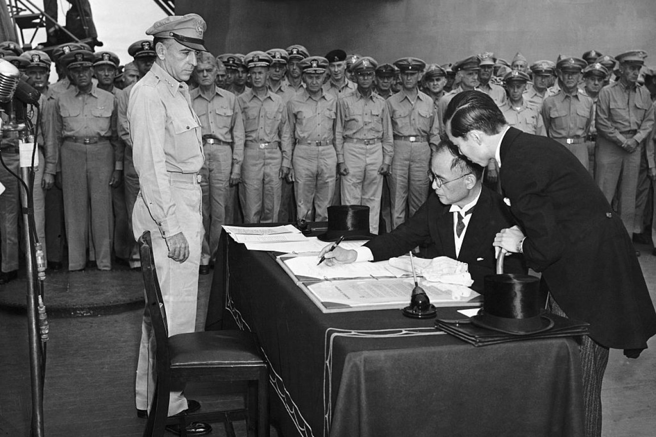 Namoro Shigomitso signs on behalf of Japan and the Japanese government during the formal surrender on the USS Missouri in Tokyo Bay.