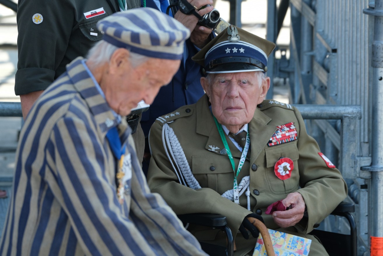 A Polish military veteran and a concentration camp survivor at the Warsaw commemoration.
