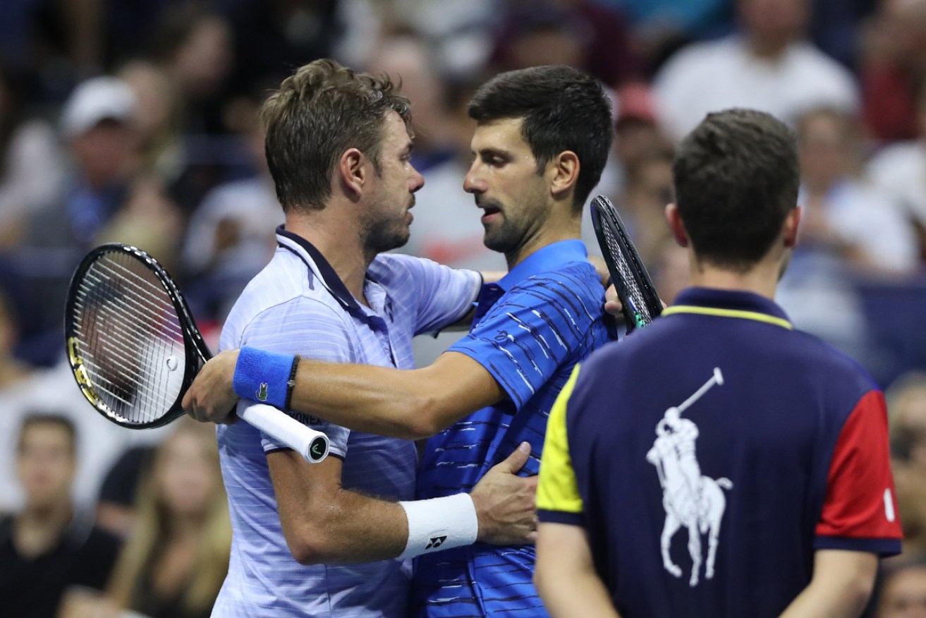 Stan Wawrinka consoles Novak Djokovic after he was forced to retirefrom their fourth-round match 
