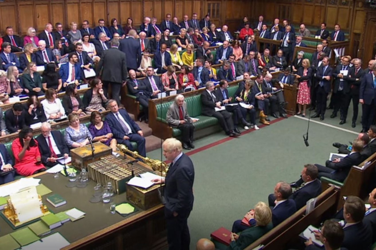 Conservative defector Dr Phillip Lee (centre standing right) takes his seat among Liberal Democrat MPs as Prime Minister Boris Johnson makes a statement to  the House of Commons.