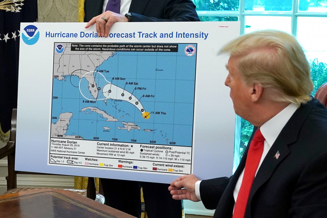 Mr Trump with the August 29 map of Dorian's predicted path – and an apparent alteration in marker pen.