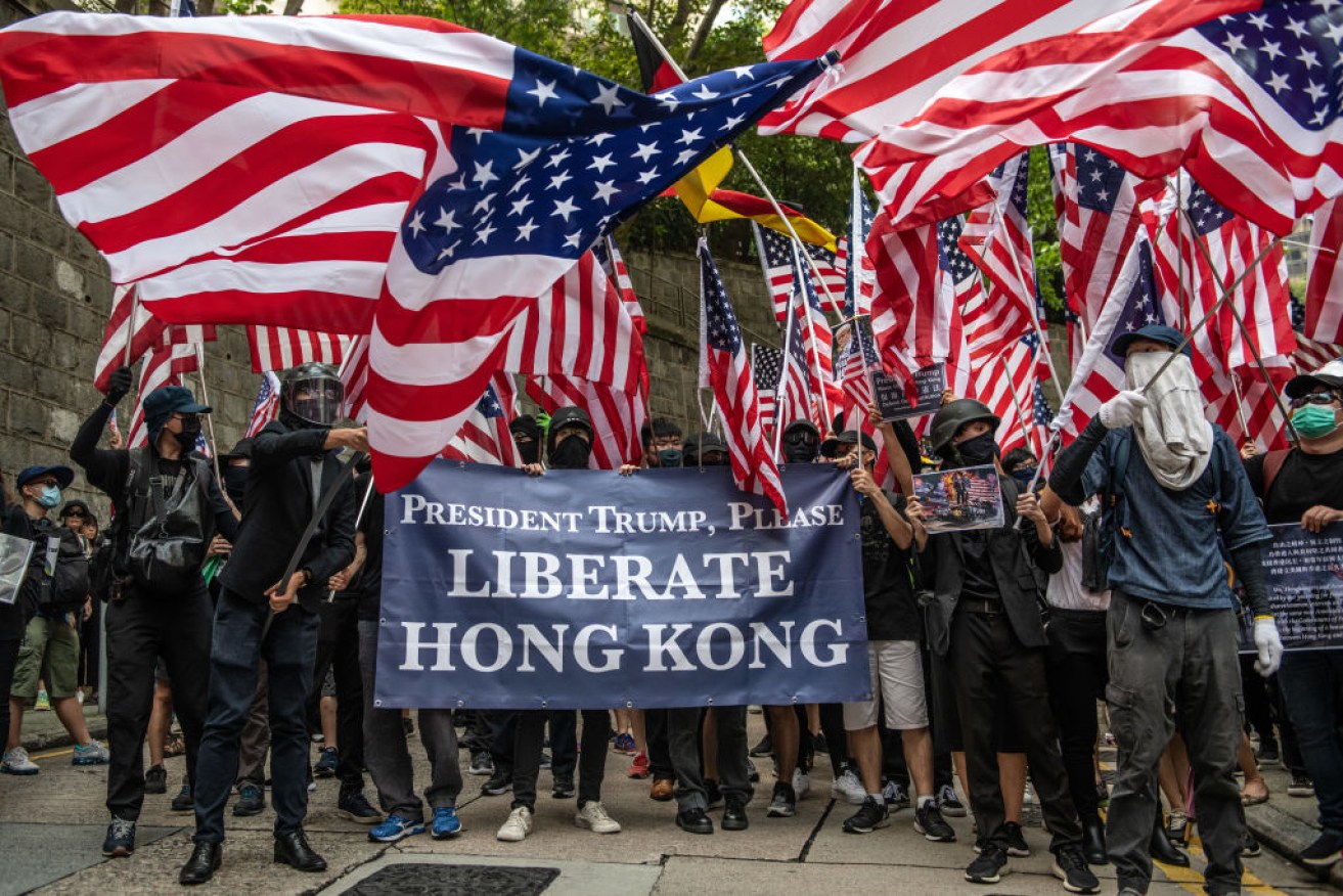 Protesters wave American flags outside the U.S consulate after delivering a petition calling on President Trump to aid their fight for freedom.