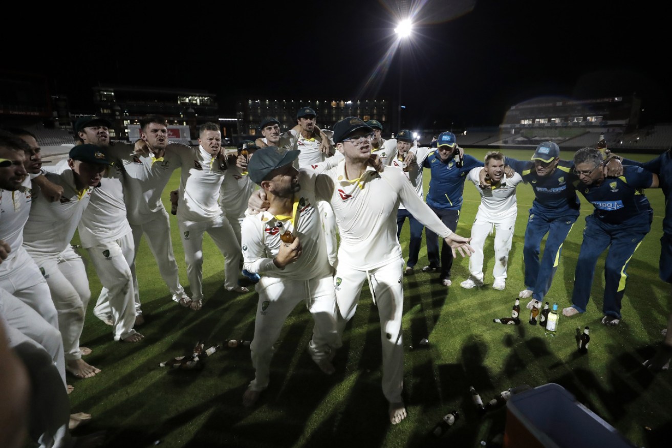 Nathan Lyon and Steve Smith celebrate Australia's Ashes-retaining win at Old Trafford. 