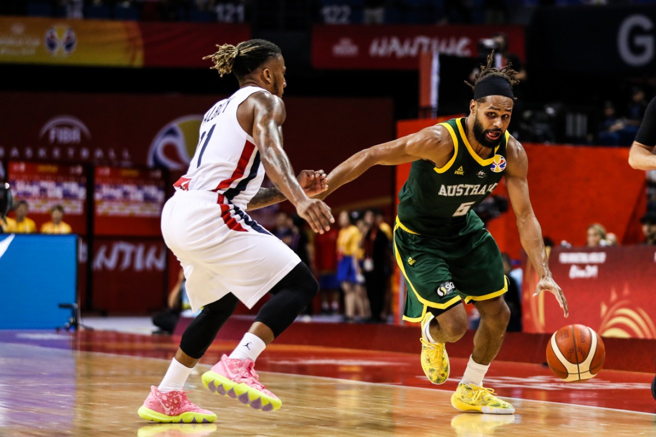 Australia's Patty Mills in action against France's Andrew Albicy.