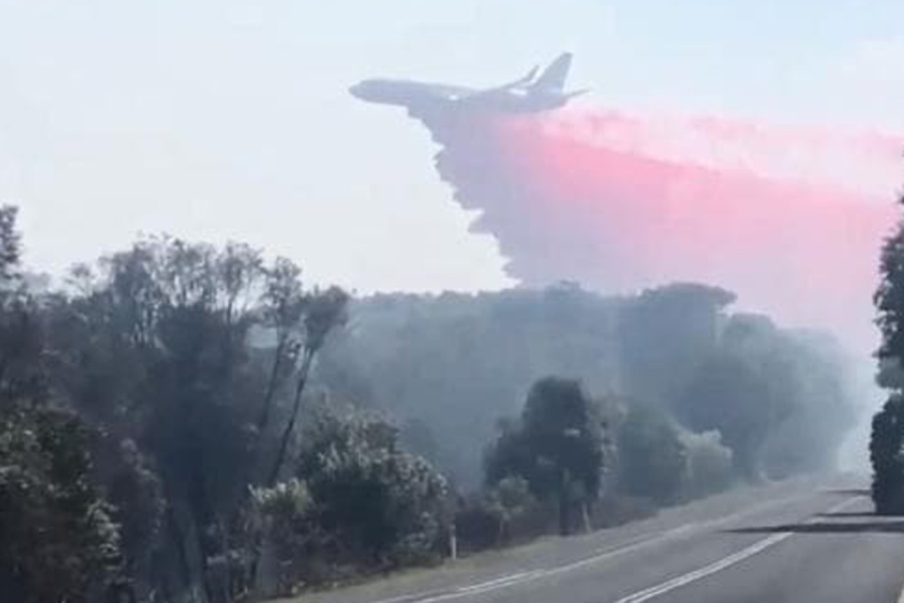 Fire retardant is dropped across the Peregian Beach fire from a 737.