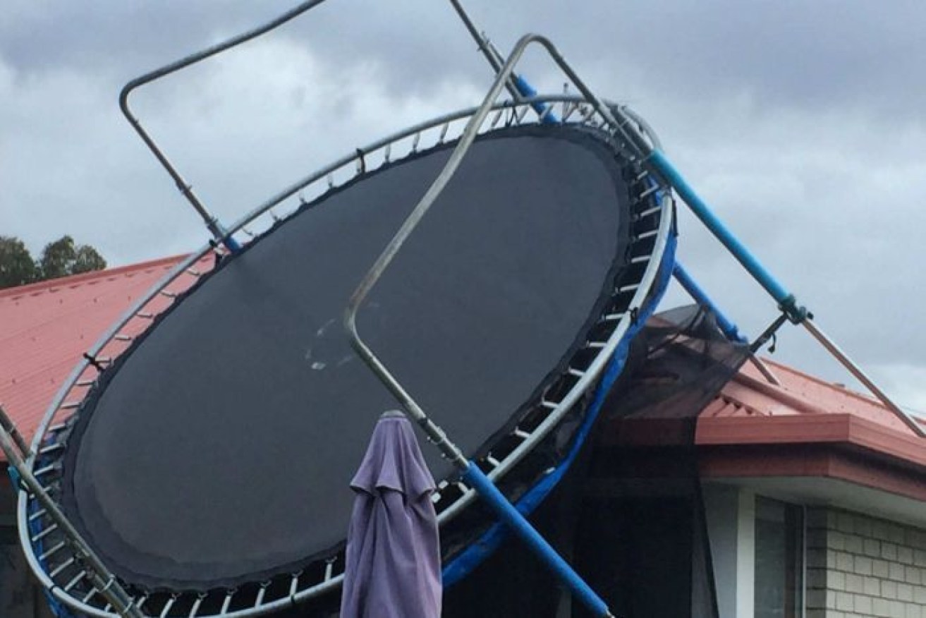The trampoline remains wedged against the roof of Jennie Pritchett's house.