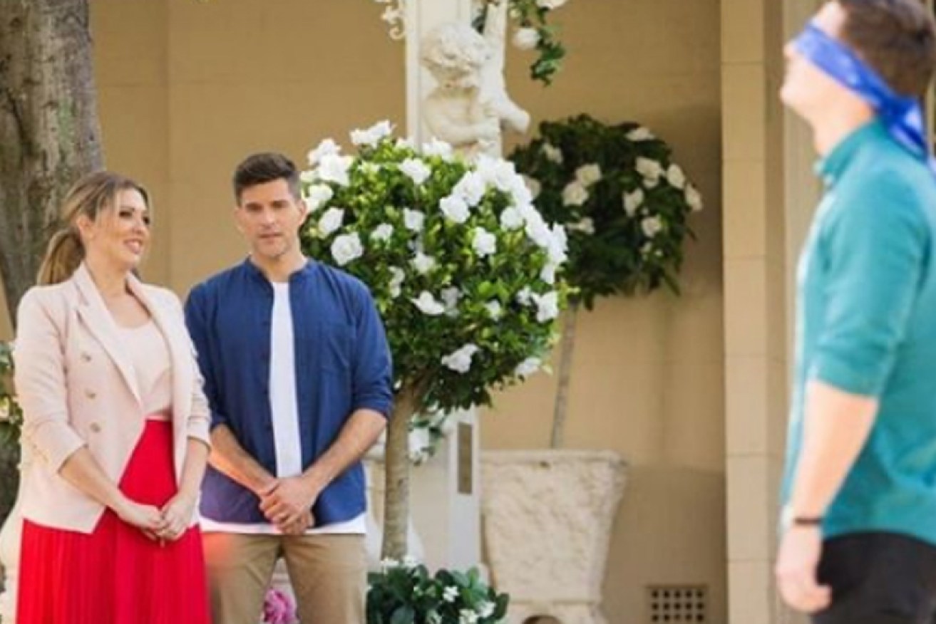 Nikki Goldstein and Osher Gunsberg lead a blind Matt Agnew on Ten's <i>The Bachelor.</i>