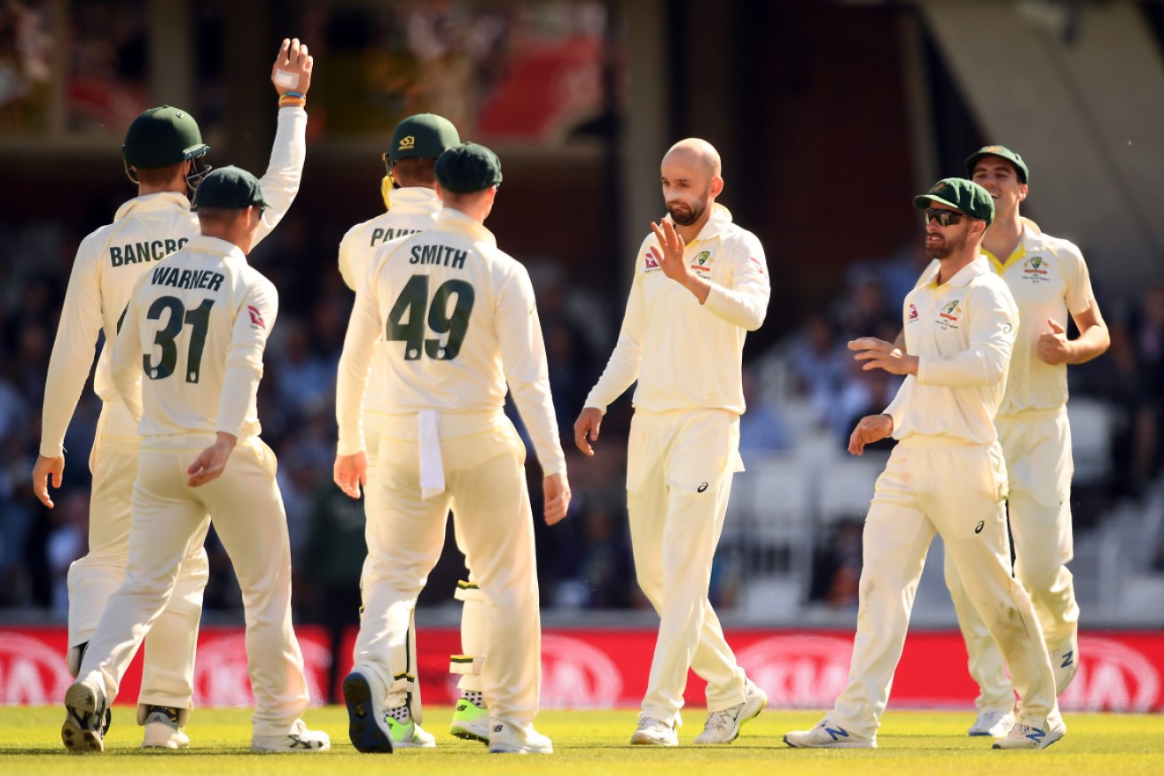 The Australians congratulate Nathan Lyon after dismissing Rory Burns. 
