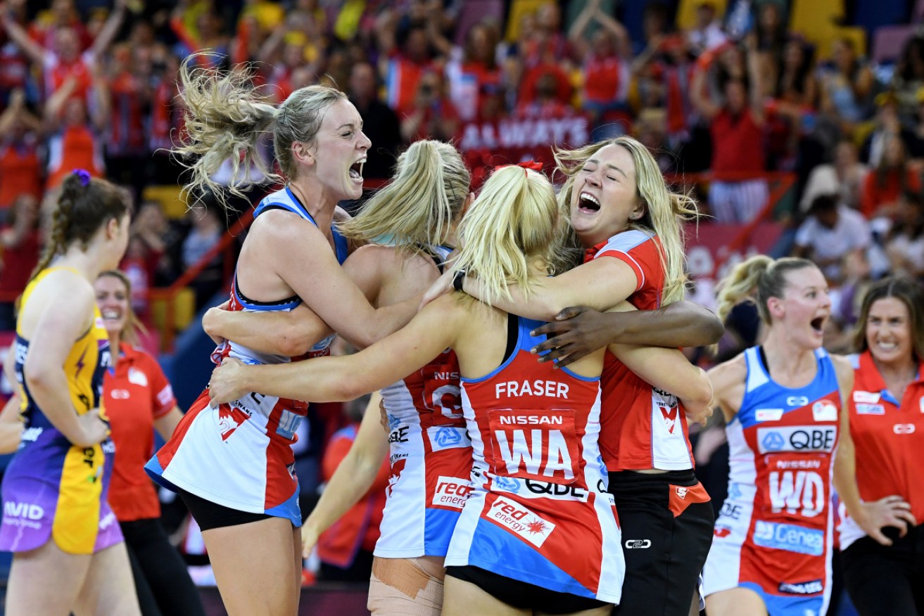 Delirious: The NSW Swifts celebrate their first premiership in 11 years. 