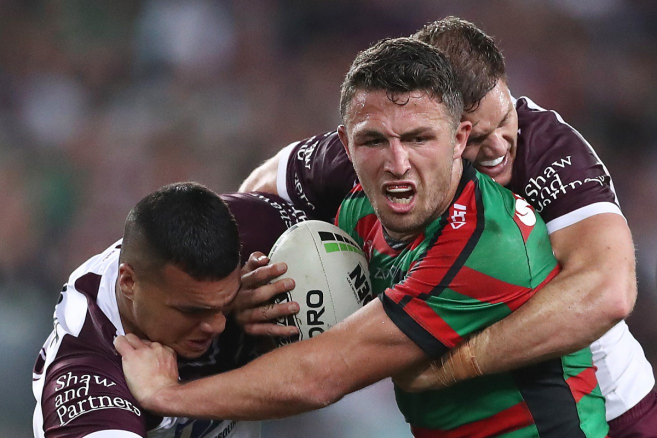 South Sydney's Sam Burgess bullocks his way through the Manly defence. 