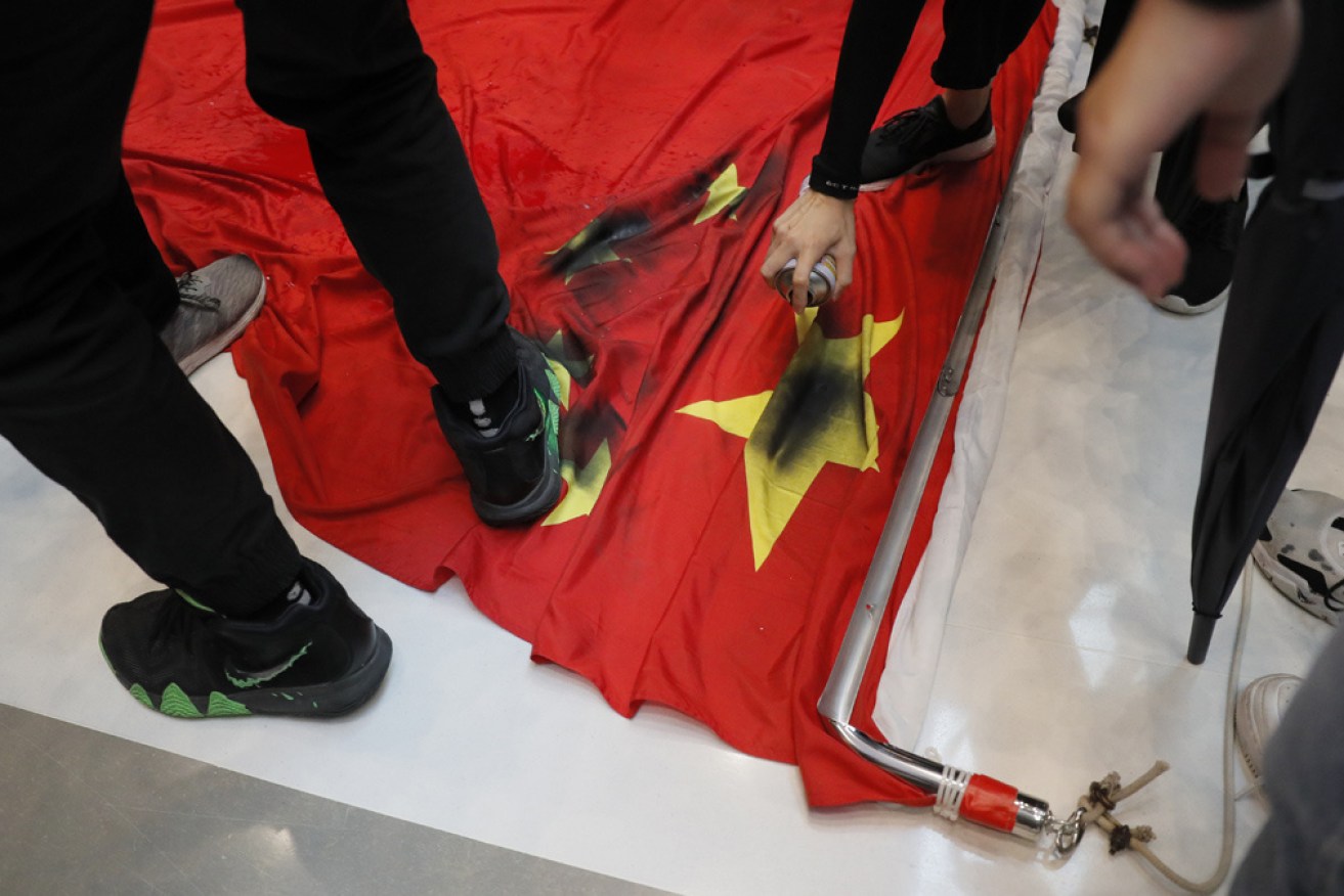 Protestors in Hong Kong trample a Chinese flag.