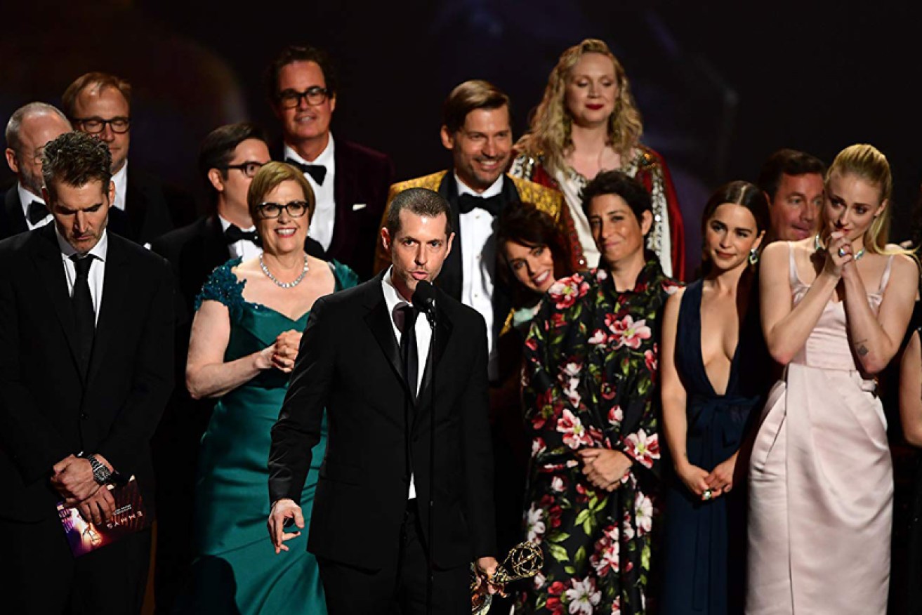 DB Weiss is surrounded by the <i>Game of Thrones</i> cast as the show wins its final Emmy.
