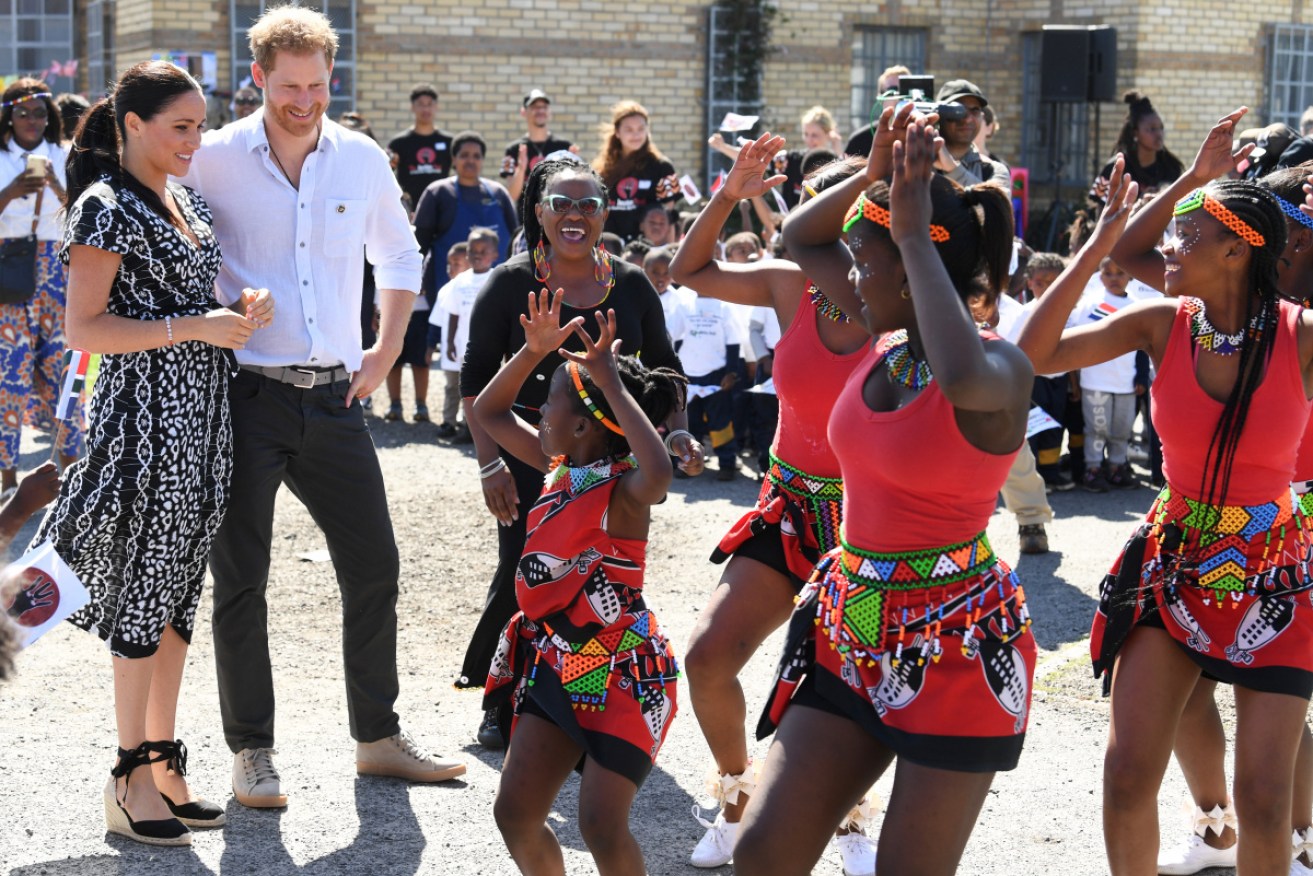 Brightly-dressed locals from the Nyanga township welcomed the royal couple.