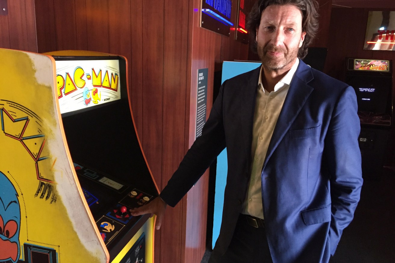 National Film and Sound Archive chief Jan Muller with a Pac-Man arcade machine during the Game Masters exhibtion.