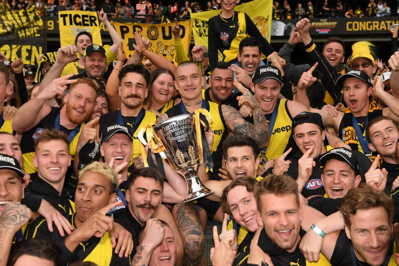 Job done: The Tigers celebrate with fans at the MCG. 