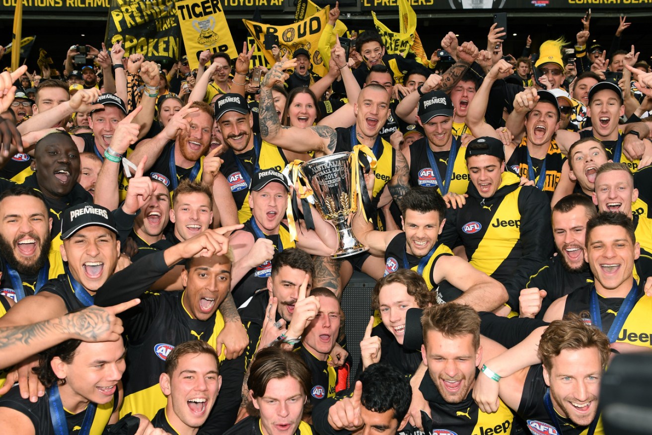 Getting better next year? The Tiger army with their winning players on Saturday at the MCG. 
