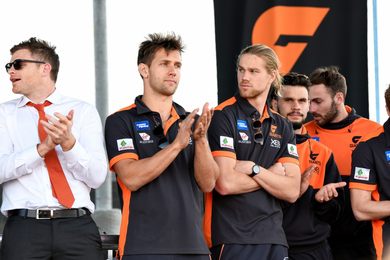 The beaten Giants players greet their supporters at their home ground on Sunday.