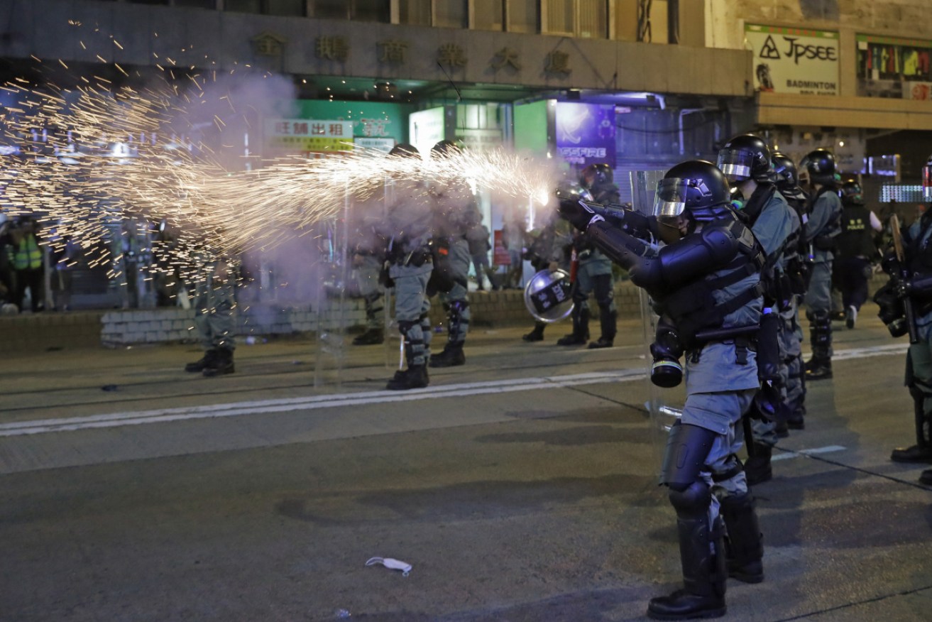Riot police fired tear gas on Sunday. Photo: AAP