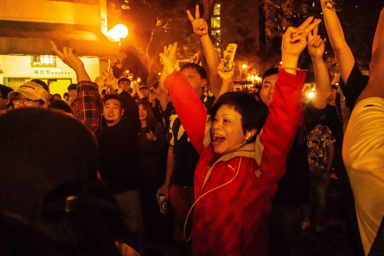 Hong Kong residents celebrate the weekend's election results.