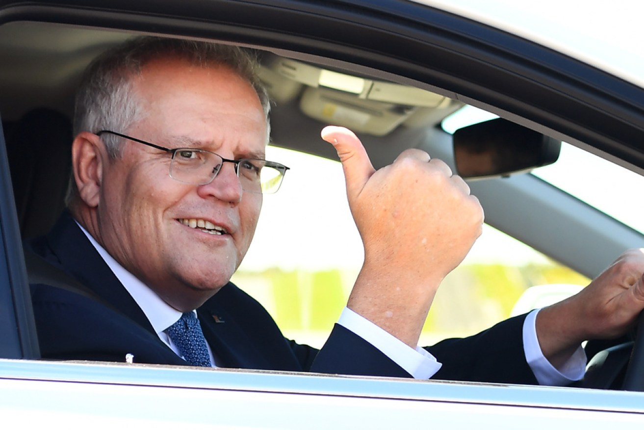 Scott Morrison drives a hydrogen-fuelled car around a Toyota test track in Melbourne.