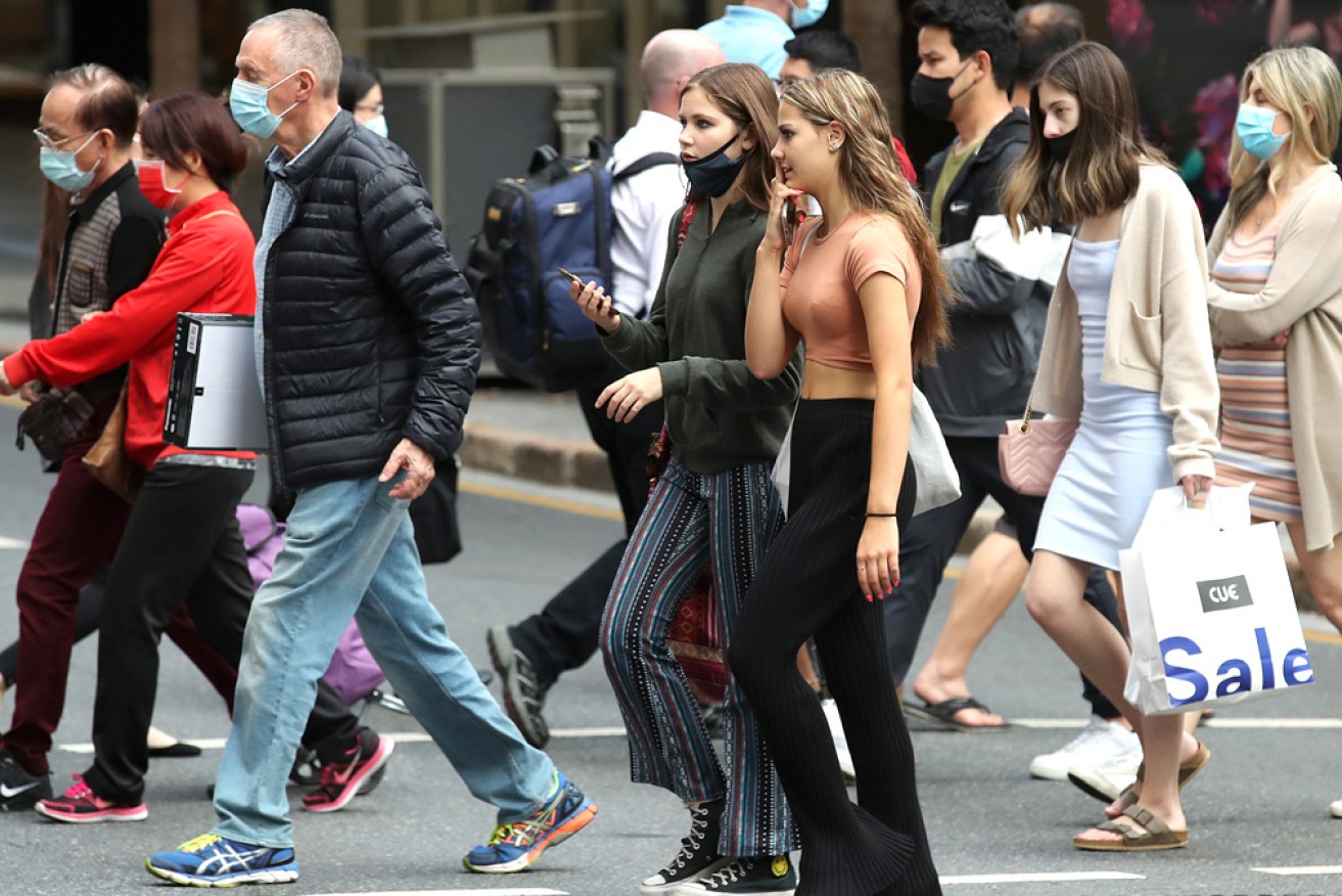 Masks are back in fashion, but with everyone, as COVID rages in Queensland. <i>Photo: Getty</I>
