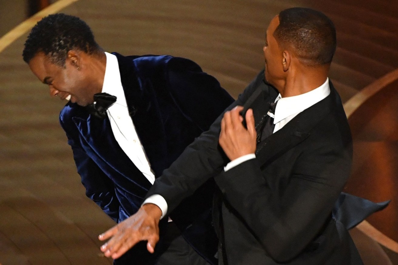 Chris Rock reels as Will Smith expresses his displeasure at a gag about his wife.