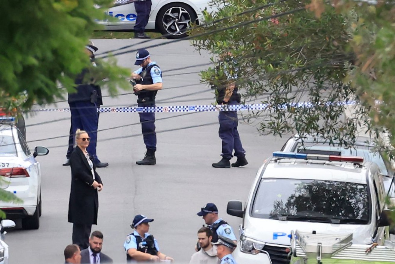 Police shot dead a man on Sydney's lower north shore after he allegedly threatened them with knives.