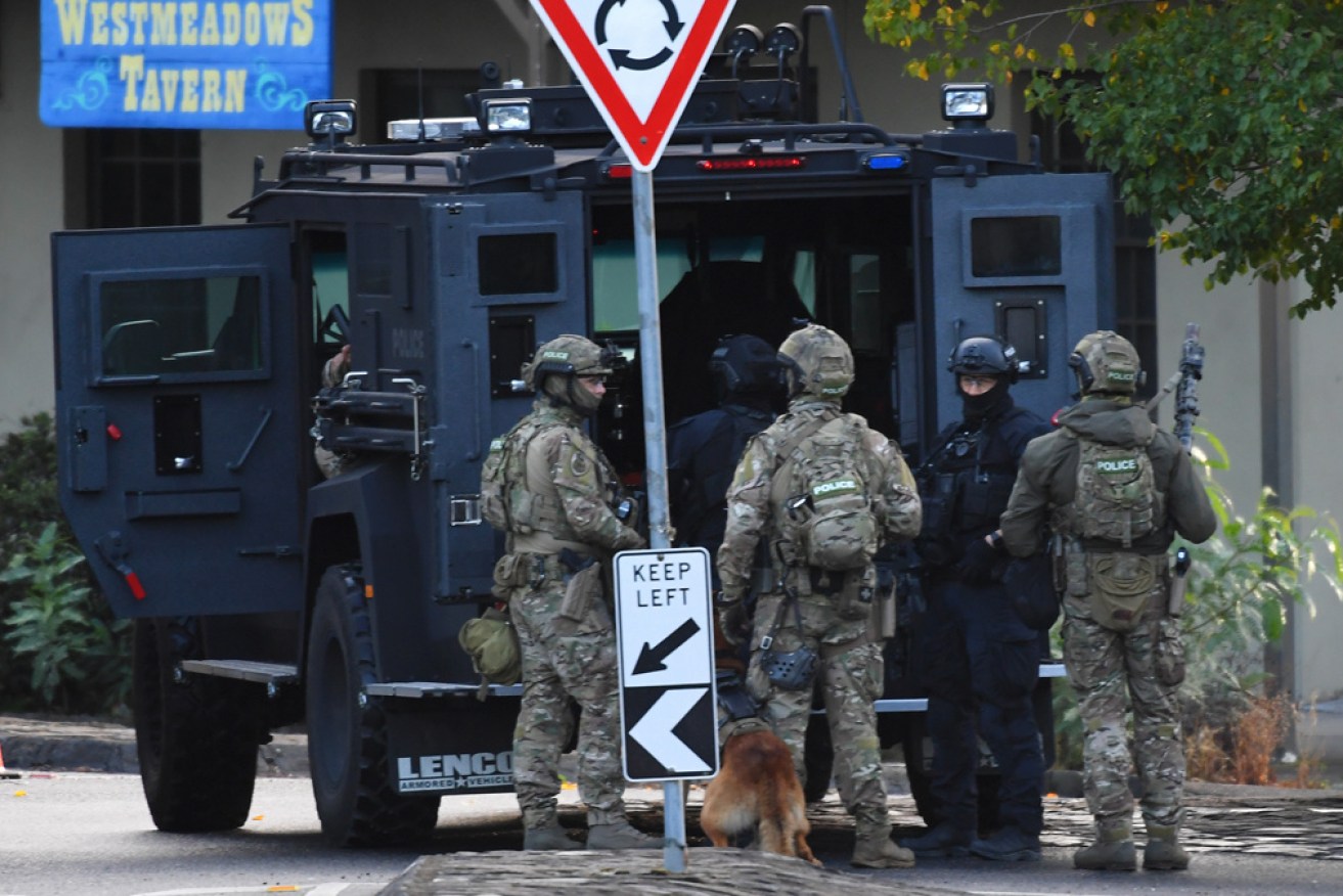 Police outside the Westmeadows pub during the siege that followed the robbery.